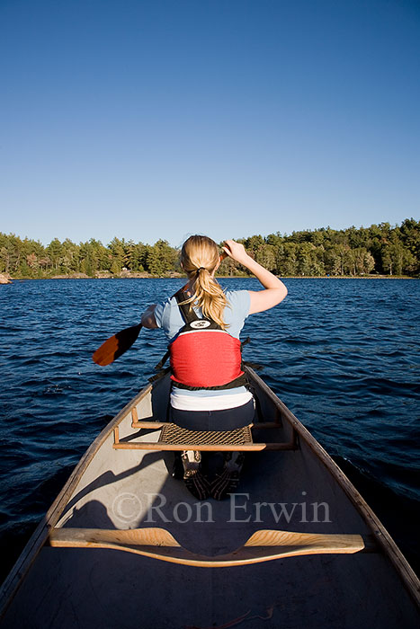 Woman Paddling a Canoe